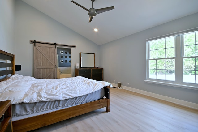 1422 Deer Creek Ln, Lake In The Hills, IL 60156 - bedroom with a barn door, multiple windows, wood finished floors, baseboards, and vaulted ceiling
