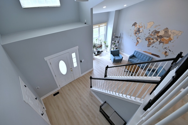 1422 Deer Creek Ln, Lake In The Hills, IL 60156 - foyer featuring a towering ceiling, wood finished floors, and baseboards