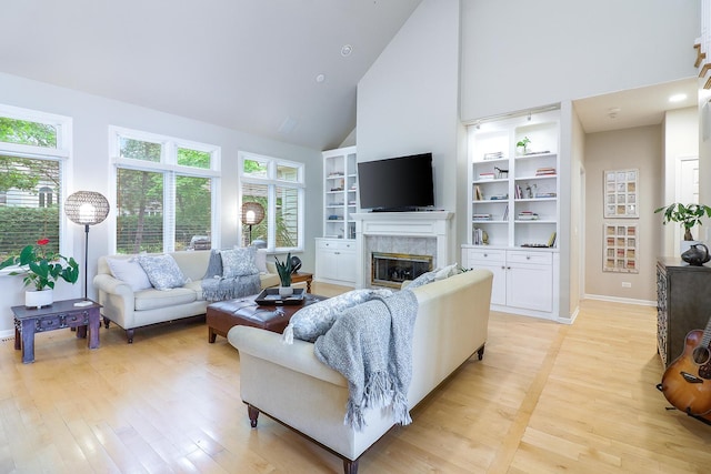 3536 Scottsdale Cir, Naperville, IL 60564 - living area with high vaulted ceiling, a premium fireplace, light wood-style flooring, and built in shelves