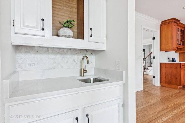 1181 Midwest Ln, Wheaton, IL 60189 - indoor wet bar with decorative backsplash, crown molding, light wood finished floors, stairs, and baseboards