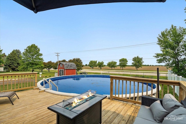 303 Meadows Dr, Sugar Grove, IL 60554 - view of swimming pool with an outdoor fire pit, a wooden deck, and a lawn