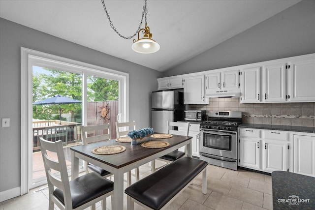 303 Meadows Dr, Sugar Grove, IL 60554 - kitchen with appliances with stainless steel finishes, dark countertops, under cabinet range hood, lofted ceiling, and white cabinetry