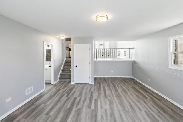 922 E 155th St, Phoenix, IL 60426 - unfurnished living room featuring wood finished floors, baseboards, and stairway