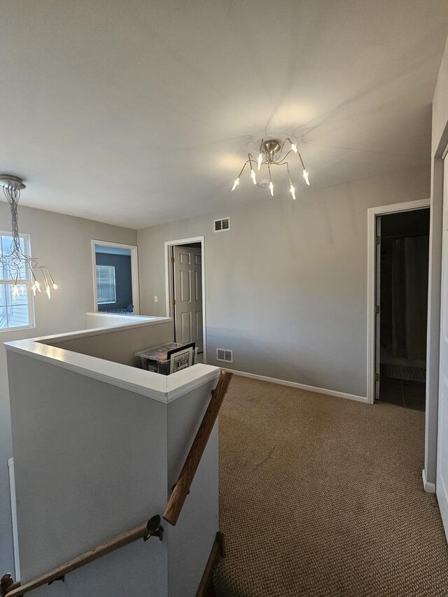 8314 Sierra Woods Ln, Carpentersville, IL 60110 - carpeted spare room featuring a chandelier and baseboards