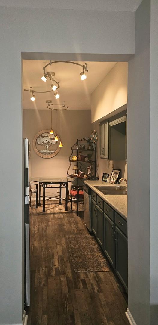 8314 Sierra Woods Ln, Carpentersville, IL 60110 - hall featuring a sink and dark wood-style flooring