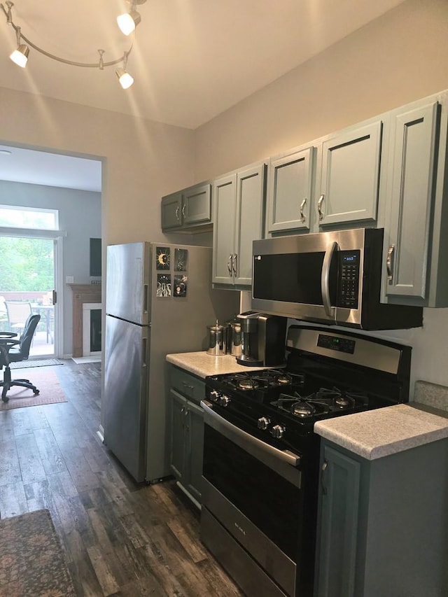 8314 Sierra Woods Ln, Carpentersville, IL 60110 - kitchen featuring stainless steel appliances, dark wood-type flooring, light countertops, and gray cabinetry