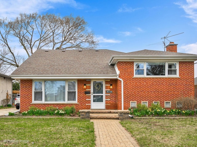 4048 W 105th St, Oak Lawn, IL 60453 - tri-level home with brick siding, a front yard, a chimney, and roof with shingles