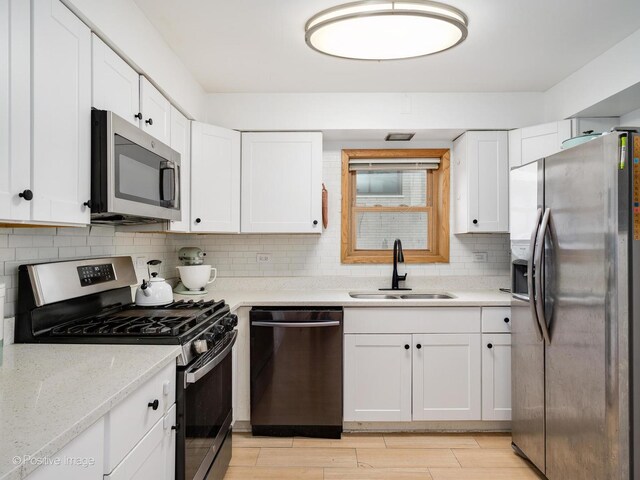 4048 W 105th St, Oak Lawn, IL 60453 - kitchen with stainless steel appliances, tasteful backsplash, white cabinets, light wood-type flooring, and light stone countertops