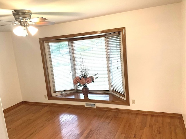 813 Junie Ct, Joliet, IL 60435 - empty room featuring wood finished floors and a ceiling fan