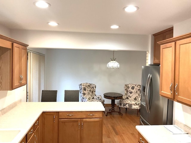 813 Junie Ct, Joliet, IL 60435 - kitchen with stainless steel refrigerator with ice dispenser, a peninsula, wood finished floors, light countertops, and brown cabinetry