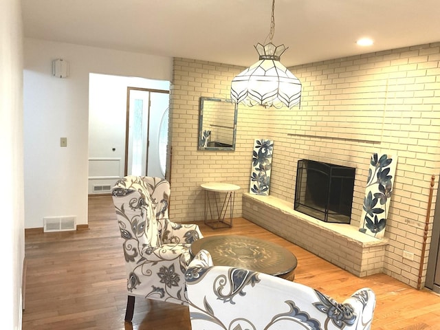 813 Junie Ct, Joliet, IL 60435 - living room with wood finished floors, a fireplace, and brick wall
