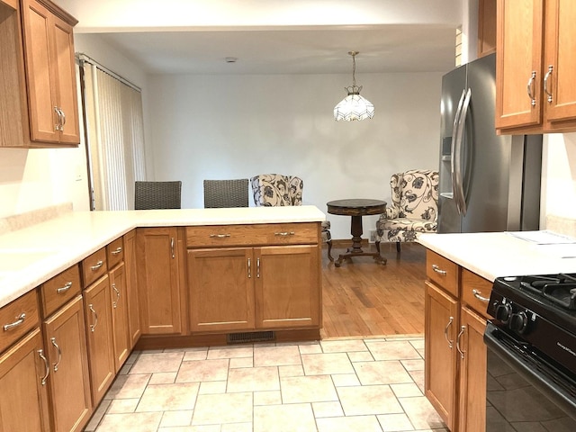813 Junie Ct, Joliet, IL 60435 - kitchen featuring a peninsula, light countertops, brown cabinets, and stainless steel refrigerator with ice dispenser