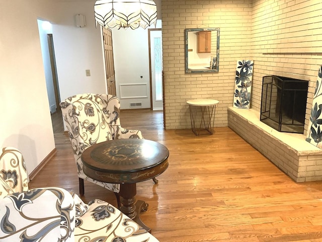 813 Junie Ct, Joliet, IL 60435 - sitting room with light wood finished floors and a brick fireplace