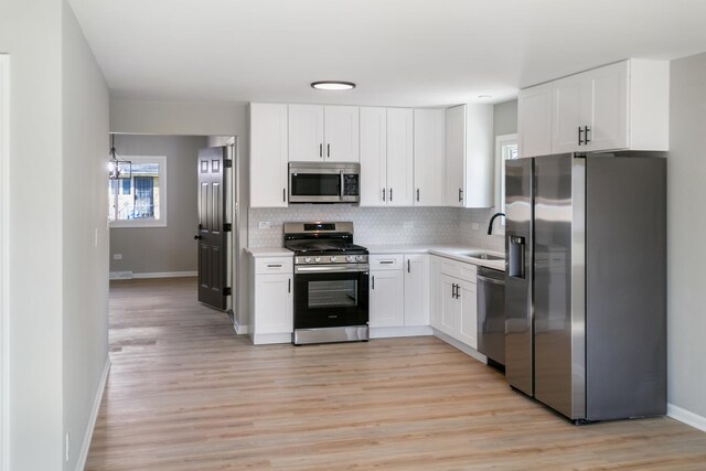 15439 Cherry St, South Holland, IL 60473 - kitchen with appliances with stainless steel finishes, decorative backsplash, baseboards, light countertops, and white cabinetry