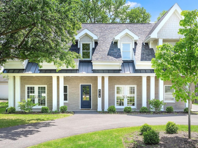608 W 55th St, Hinsdale, IL 60521 - view of front facade with a standing seam roof, brick siding, and french doors
