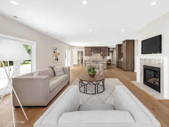 608 W 55th St, Hinsdale, IL 60521 - living room featuring light wood-style floors, recessed lighting, and a tile fireplace