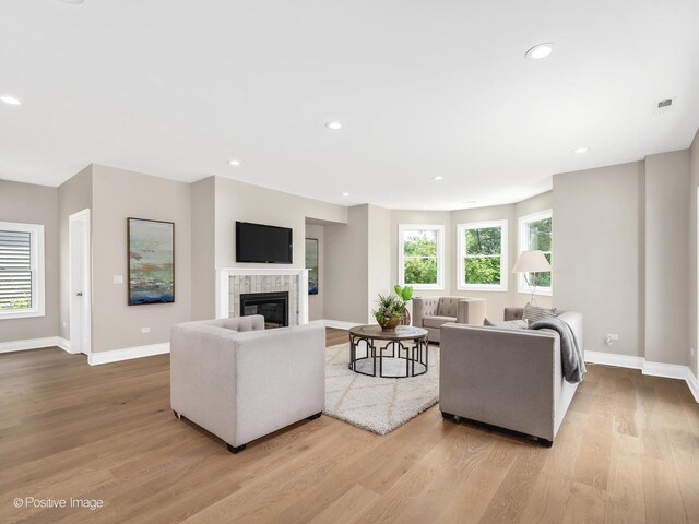 608 W 55th St, Hinsdale, IL 60521 - living room featuring wood finished floors, baseboards, a tiled fireplace, and recessed lighting