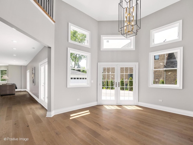 608 W 55th St, Hinsdale, IL 60521 - entryway with french doors, wood finished floors, baseboards, a towering ceiling, and a chandelier