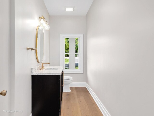 608 W 55th St, Hinsdale, IL 60521 - bathroom with toilet, wood finished floors, vanity, and baseboards