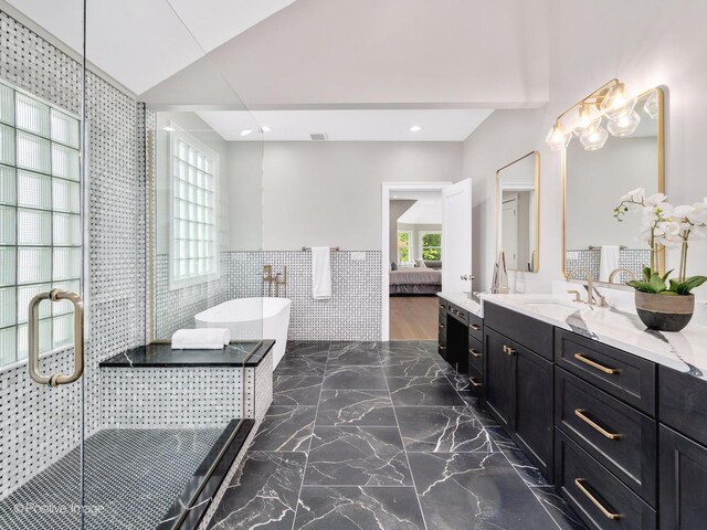 608 W 55th St, Hinsdale, IL 60521 - ensuite bathroom with a freestanding bath, tile walls, vanity, marble tiled flooring, and wainscoting
