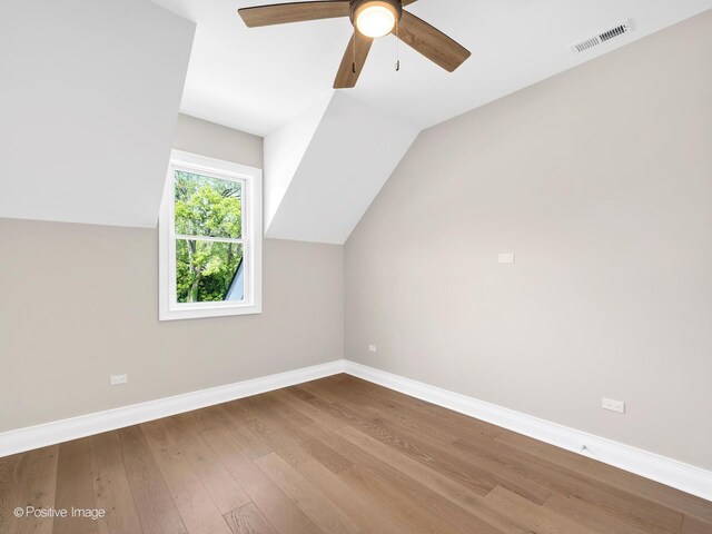 608 W 55th St, Hinsdale, IL 60521 - additional living space featuring wood finished floors, baseboards, a ceiling fan, and vaulted ceiling