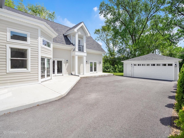 608 W 55th St, Hinsdale, IL 60521 - view of property exterior with roof with shingles, a garage, french doors, a balcony, and an outdoor structure