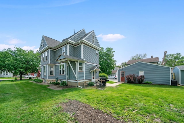 119 E 4th St, Sandwich, IL 60548 - view of side of property with a lawn, a patio, and central AC