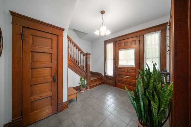 119 E 4th St, Sandwich, IL 60548 - foyer with a chandelier, stairs, and baseboards