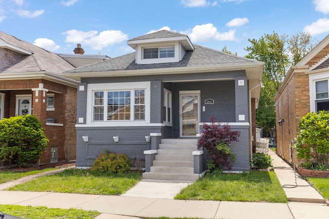 5941 W Warwick Ave, Chicago, IL 60634 - bungalow-style house with a porch, brick siding, and roof with shingles