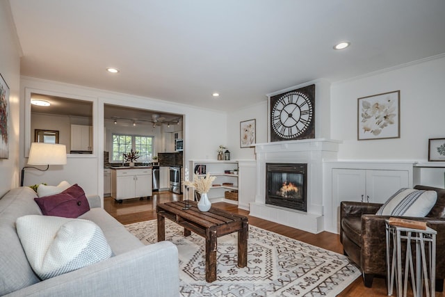 202 S Pierce Ave, Wheaton, IL 60187 - living area with ornamental molding, dark wood finished floors, a tiled fireplace, and recessed lighting