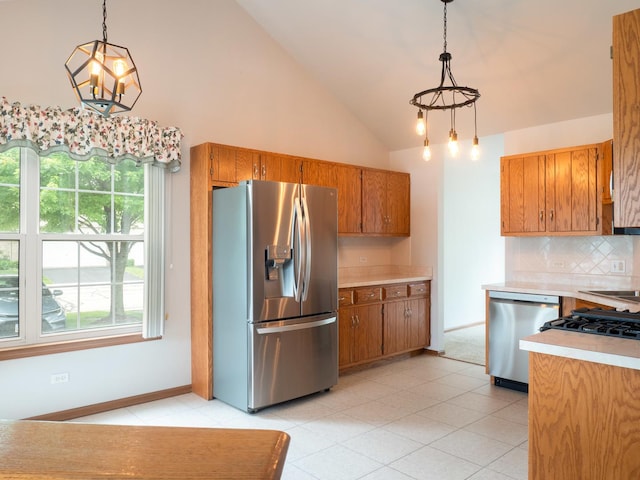 4707 Mikasa Ct, Joliet, IL 60431 - kitchen featuring appliances with stainless steel finishes, light countertops, brown cabinets, healthy amount of natural light, and high vaulted ceiling