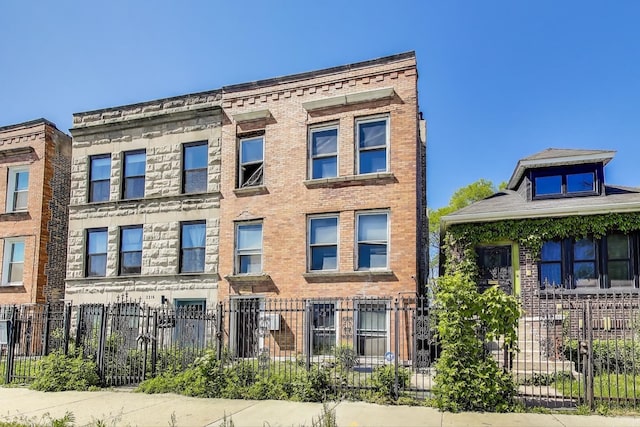 3314 W Carroll Ave, Chicago, IL 60624 - view of building exterior with a fenced front yard