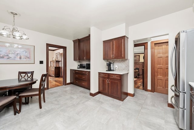 236 Country Club Rd, Chicago Heights, IL 60411 - kitchen featuring stainless steel appliances, light countertops, backsplash, a chandelier, and hanging light fixtures