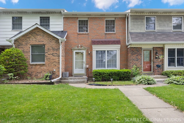 333 Monroe St, Oswego, IL 60543 - townhome / multi-family property featuring a front lawn and brick siding