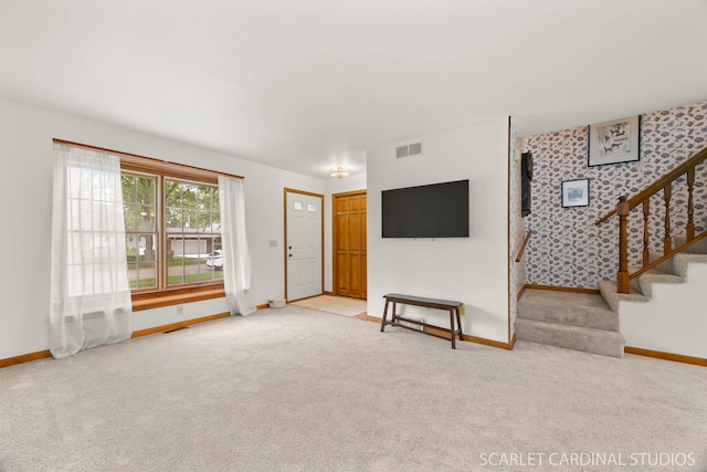 333 Monroe St, Oswego, IL 60543 - unfurnished living room with baseboards, stairs, and carpet flooring
