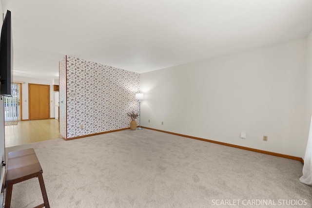 333 Monroe St, Oswego, IL 60543 - carpeted spare room with wallpapered walls, baseboards, and an accent wall