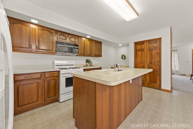 333 Monroe St, Oswego, IL 60543 - kitchen featuring white appliances, light flooring, light countertops, a sink, and recessed lighting