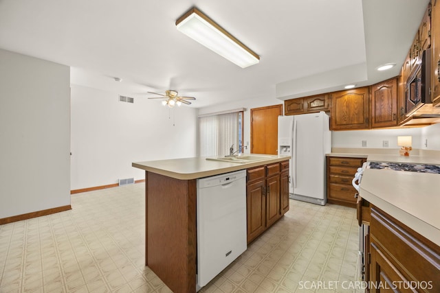 333 Monroe St, Oswego, IL 60543 - kitchen featuring white appliances, light floors, a sink, light countertops, and baseboards