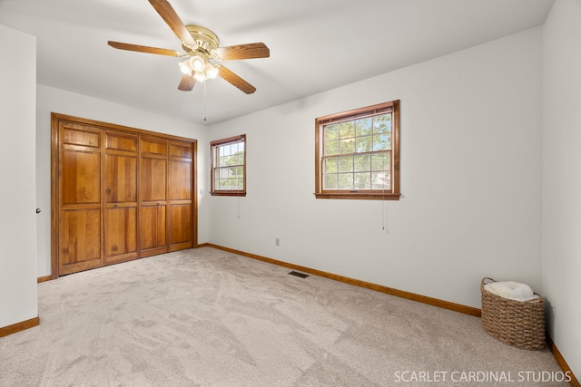 333 Monroe St, Oswego, IL 60543 - unfurnished bedroom featuring baseboards, carpet flooring, a closet, and ceiling fan