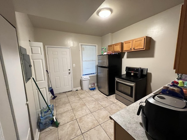801 S Kedvale Ave, Chicago, IL 60624 - kitchen featuring appliances with stainless steel finishes, light tile patterned flooring, light countertops, and electric panel