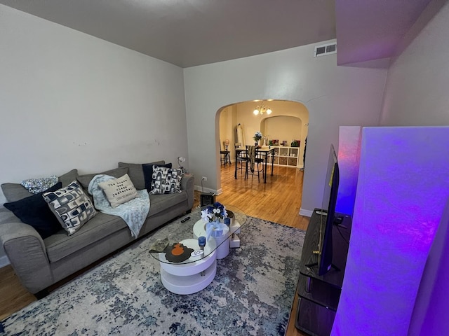 801 S Kedvale Ave, Chicago, IL 60624 - living area featuring arched walkways, wood finished floors, and baseboards