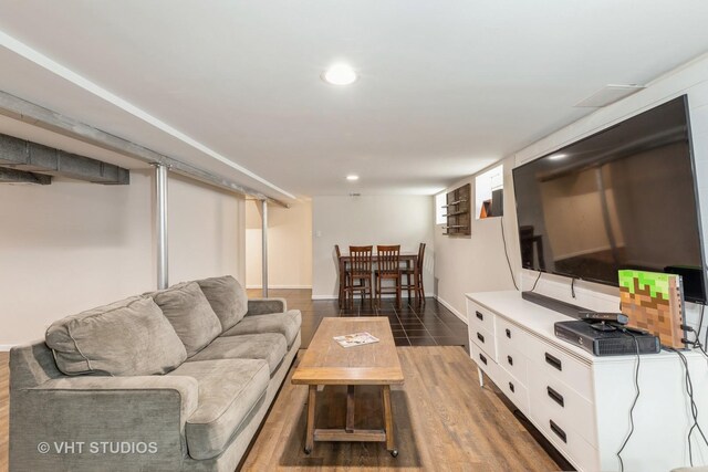 living area with wood finished floors and recessed lighting