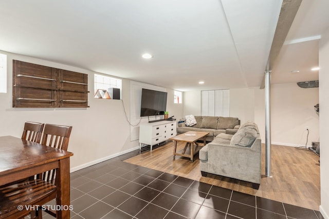 living area with dark tile patterned flooring and recessed lighting