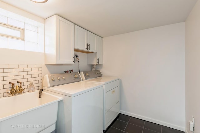 washroom featuring cabinet space, independent washer and dryer, and dark tile patterned floors