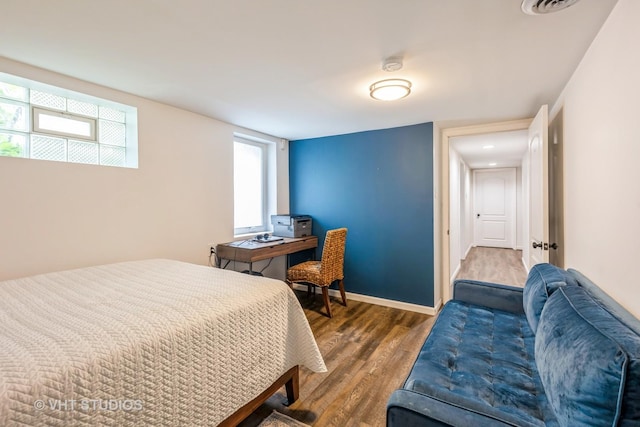 bedroom featuring wood finished floors and baseboards