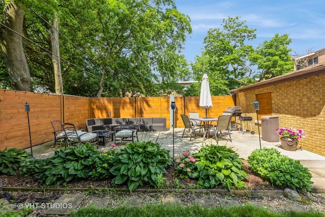 fenced backyard with an outdoor hangout area, a patio, and grilling area
