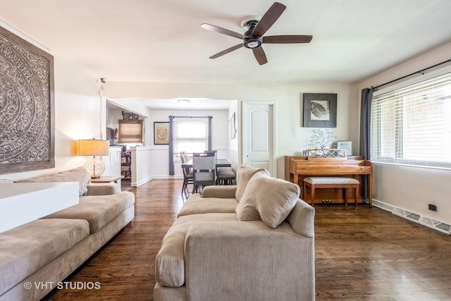 living area featuring a ceiling fan and wood finished floors