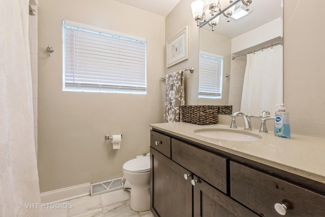full bathroom with marble finish flooring, vanity, a shower with shower curtain, and a chandelier