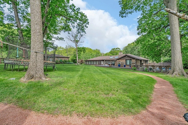 9109 W 123rd St, Palos Park, IL 60464 - view of green lawn with a trampoline and a deck