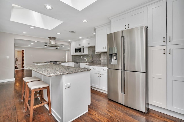 9109 W 123rd St, Palos Park, IL 60464 - kitchen with stainless steel appliances, a skylight, island range hood, tasteful backsplash, and dark wood-style floors